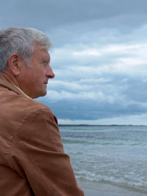 Elderly man overlooking beach