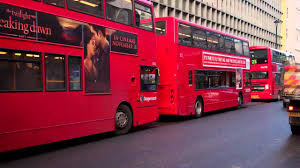 A puréed and simmering carrot soup in a pot with a spoon