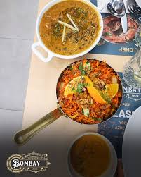 A puréed and simmering carrot soup in a pot with a spoon