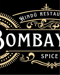 A puréed and simmering carrot soup in a pot with a spoon