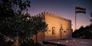 A puréed and simmering carrot soup in a pot with a spoon