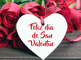 A puréed and simmering carrot soup in a pot with a spoon