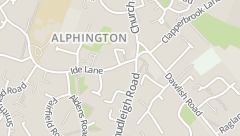 A puréed and simmering carrot soup in a pot with a spoon