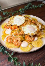 A puréed and simmering carrot soup in a pot with a spoon
