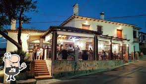 A puréed and simmering carrot soup in a pot with a spoon