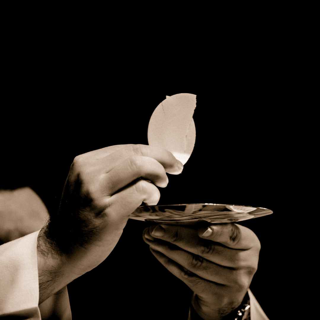 Priest giving communion